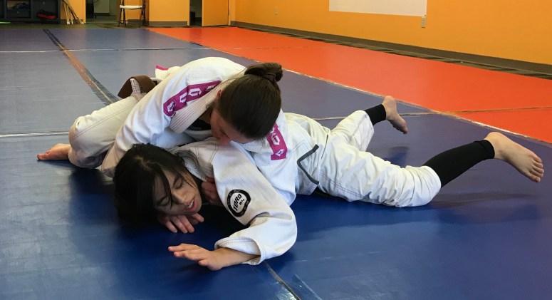 Jen switches her hip and leans on Liz to complete the pressure and possibly add a choke attack
